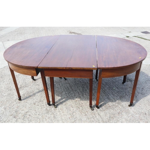 535 - A late Georgian mahogany dining table with centre section, on square taper supports and brass bracke... 