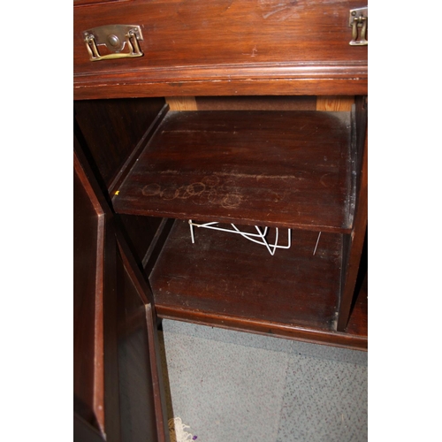 537 - A Victorian walnut mirror back dresser with flanking columns over two drawers and cupboards, on brac... 