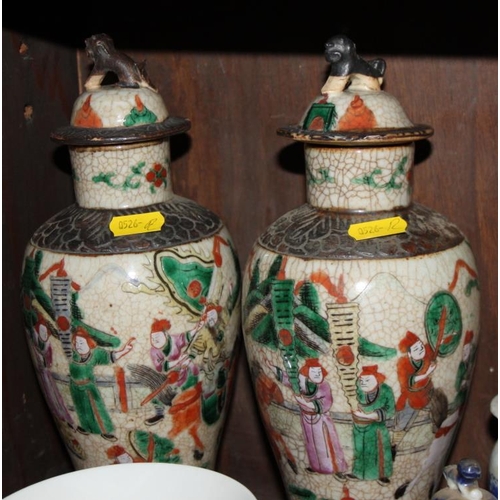 107 - A pair of Canton enamel vases, decorated warriors, 10