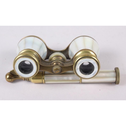 119 - A pair of mother-of-pearl and gilt metal opera glasses, on telescopic handle