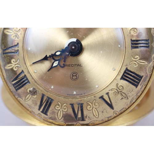 120 - A Jaeger travelling alarm clock with gilt dial and Roman numerals and scrolled and pierced case