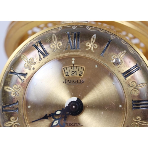 120 - A Jaeger travelling alarm clock with gilt dial and Roman numerals and scrolled and pierced case