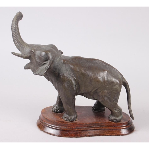 128 - A Spelter model of an elephant, on oak stand, 8