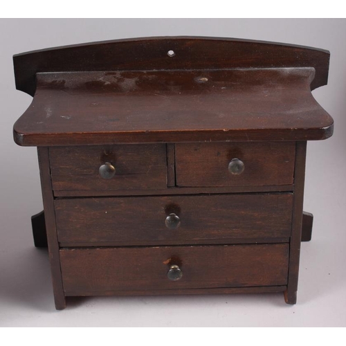 165 - A 19th century miniature chest of two short and three long drawers, on bracket supports, 10