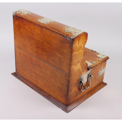 166 - An early 20th century oak tantalus with silver plated mounts, fitted two hinged flaps enclosing fitt... 