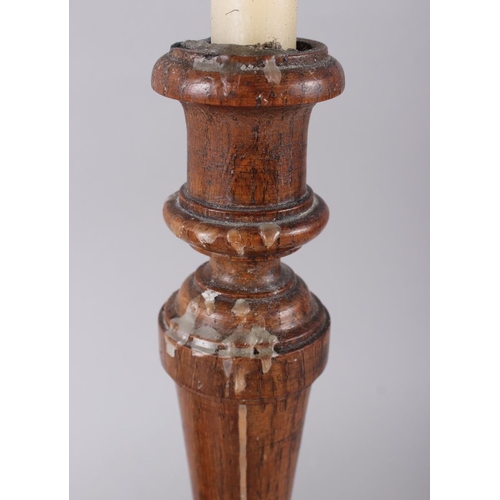 169 - A pair of turned oak candlesticks, 12