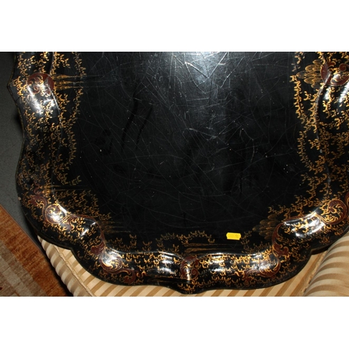 218 - A 19th century papier-mache tray with gilt decorated border, 30