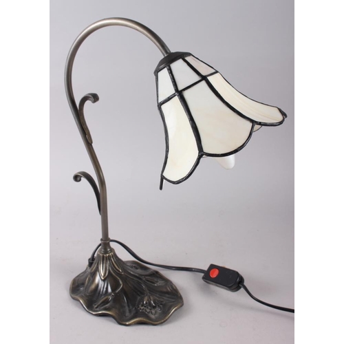 225 - A Tiffany design table lamp with cream coloured glass panels, on metal base, decorated relief flower... 