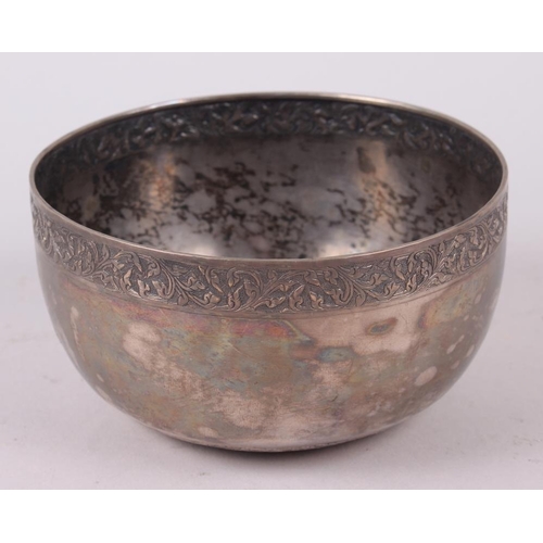 306 - A Thai white metal bowl with engraved rim and base, 6