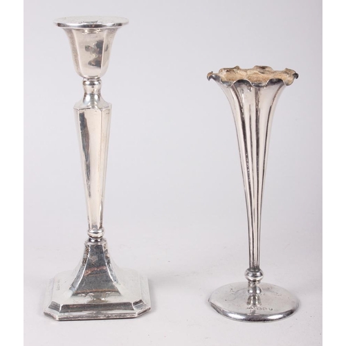 311 - A silver hand mirror, a filled silver candlestick and a silver specimen vase with weighted base