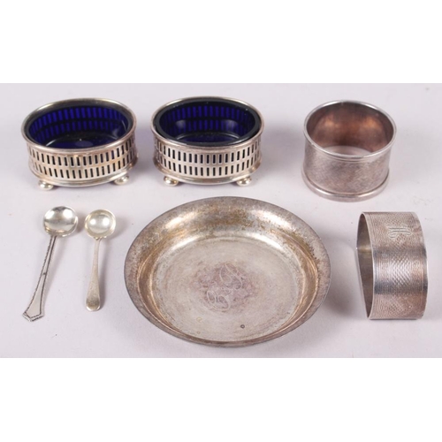 312 - A pair of silver salts with blue glass liners, two silver salt spoons, a silver pin dish and two sil... 