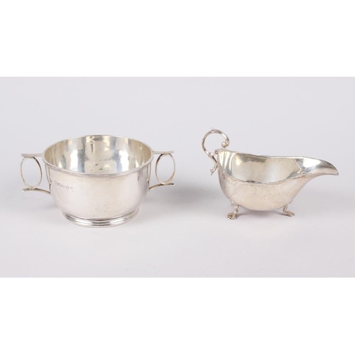 322 - A two-handled silver porringer, engraved initials, and a silver sauce boat with cut edge, 7oz troy a... 