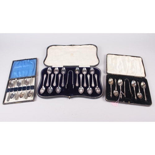 323 - A cased set of six silver apostle teaspoons with matching tongs and two other silver plated sets of ... 