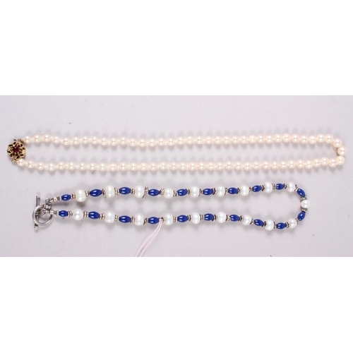 336 - A string of graduated cultured pearls with 9ct gold and garnet clasp, 20 1/2