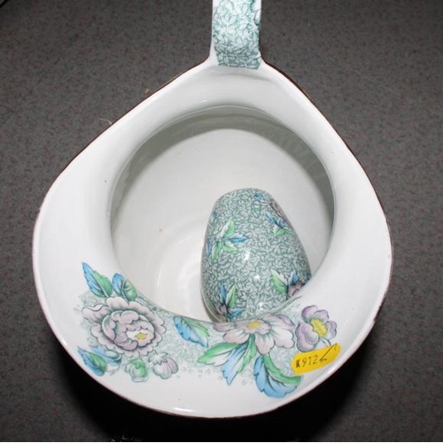 35 - A Chintz decorated toilet set and another similar with blue marbled decoration