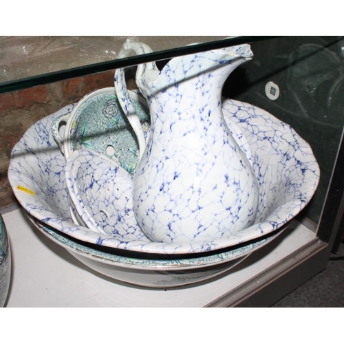 35 - A Chintz decorated toilet set and another similar with blue marbled decoration