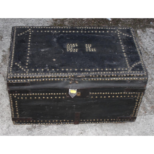 502 - A Victorian black nailed leather trunk, lid decorated initials 