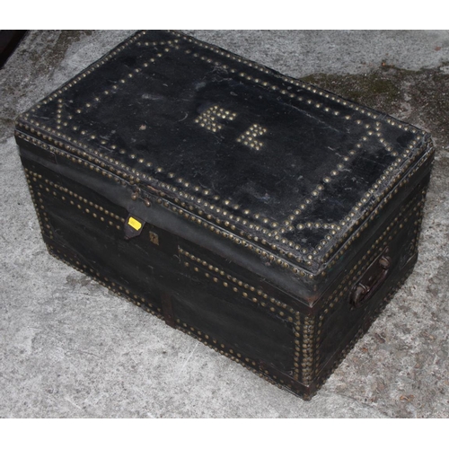 502 - A Victorian black nailed leather trunk, lid decorated initials 