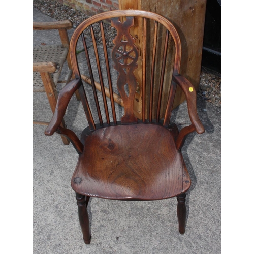 503 - An oak provincial country armchair with rush seat and an oak and elm Windsor wheelback armchair