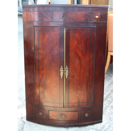 518 - A Georgian bowfront mahogany corner cabinet inlaid ebony stringing, 33