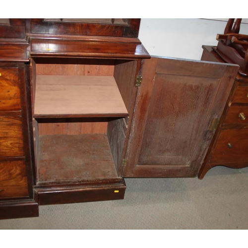 520 - An early 19th century mahogany breakfront library bookcase, fitted astragal beaded glazed doors, bas... 