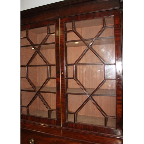 520 - An early 19th century mahogany breakfront library bookcase, fitted astragal beaded glazed doors, bas... 