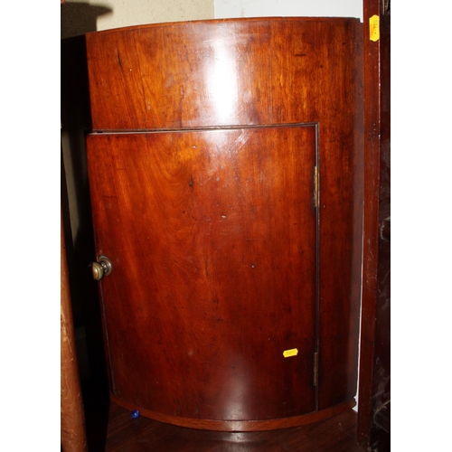 545 - A 19th century plain bowfront mahogany corner cabinet with tray top, 21