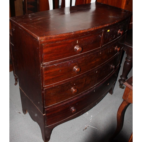 547 - An early 19th century mahogany bowfront chest of two short and three long drawers with turned wooden... 