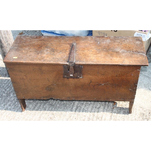 549 - A 17th century oak plank chest with iron lock and staple hinges, 36