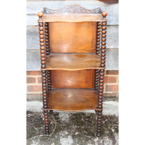 555 - A Victorian walnut three-tier whatnot with fretted gallery, on bobbin turned supports, 14 3/4