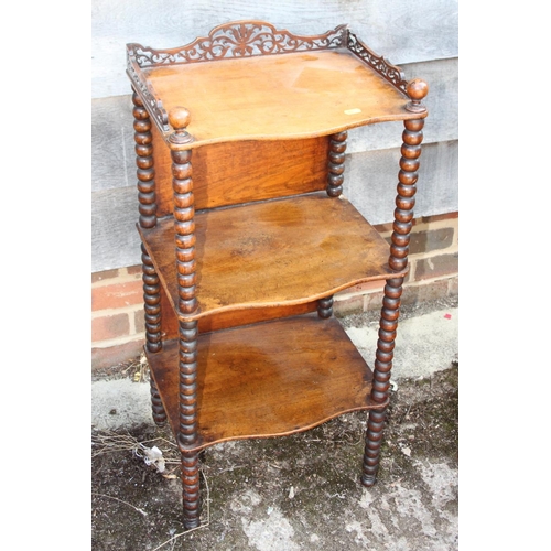 555 - A Victorian walnut three-tier whatnot with fretted gallery, on bobbin turned supports, 14 3/4