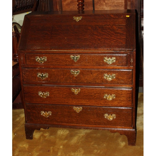 566 - A Georgian oak fall front bureau, fitted four drawers with brass handles, 38