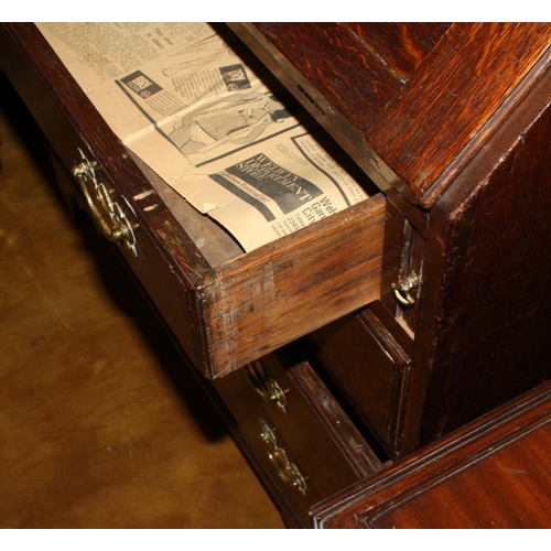 566 - A Georgian oak fall front bureau, fitted four drawers with brass handles, 38