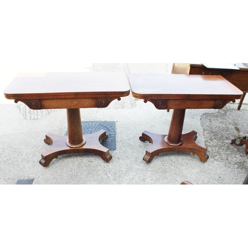 575 - A pair of 19th century rosewood fold over top tables, on plain central stems and shaped platform bas... 