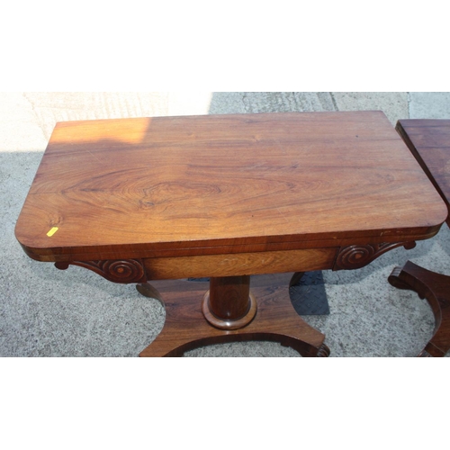 575 - A pair of 19th century rosewood fold over top tables, on plain central stems and shaped platform bas... 