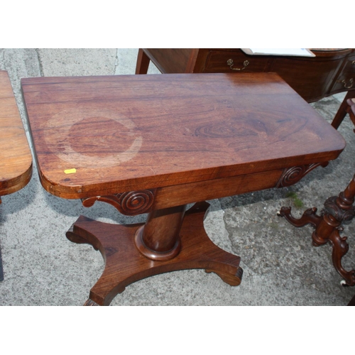 575 - A pair of 19th century rosewood fold over top tables, on plain central stems and shaped platform bas... 