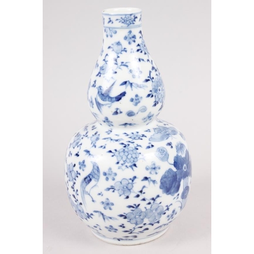 89 - A 19th century Chinese blue and white double gourd vase, decorated birds amongst foliage, 7