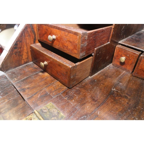 543 - An early 18th century crossbanded walnut bureau with stepped interior and two short and two long dra... 