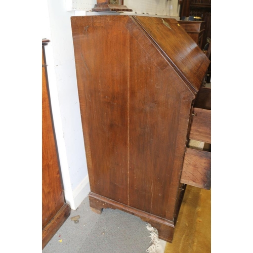 543 - An early 18th century crossbanded walnut bureau with stepped interior and two short and two long dra... 