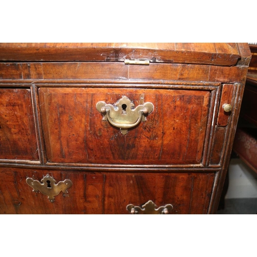 543 - An early 18th century crossbanded walnut bureau with stepped interior and two short and two long dra... 