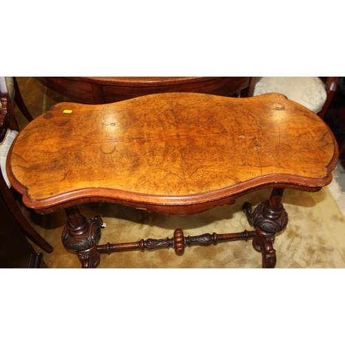 571 - A Victorian walnut rectangular occasional table, on turned and carved end supports