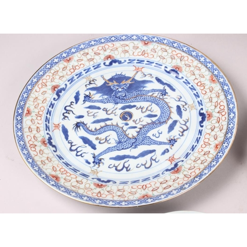 69 - Two Chinese blue and white dragon decorated dishes with six character marks to bases, similar plates... 