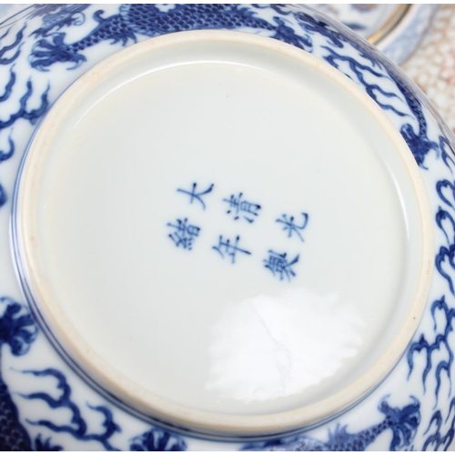 69 - Two Chinese blue and white dragon decorated dishes with six character marks to bases, similar plates... 