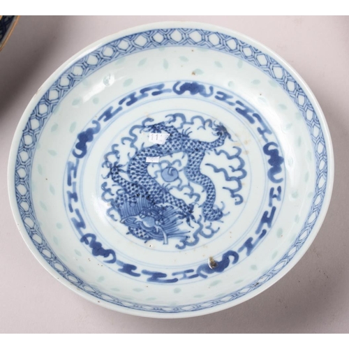 69 - Two Chinese blue and white dragon decorated dishes with six character marks to bases, similar plates... 