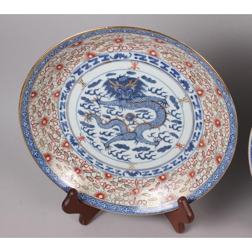 69 - Two Chinese blue and white dragon decorated dishes with six character marks to bases, similar plates... 