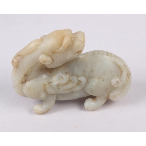 95 - A Chinese carved jade model of a dragon, on hardwood stand, 3 1/4