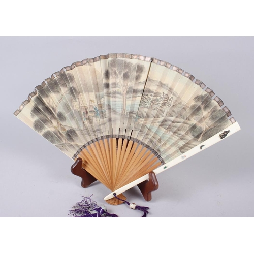 98 - A Shibayama fan and a carved ivory oval picture frame