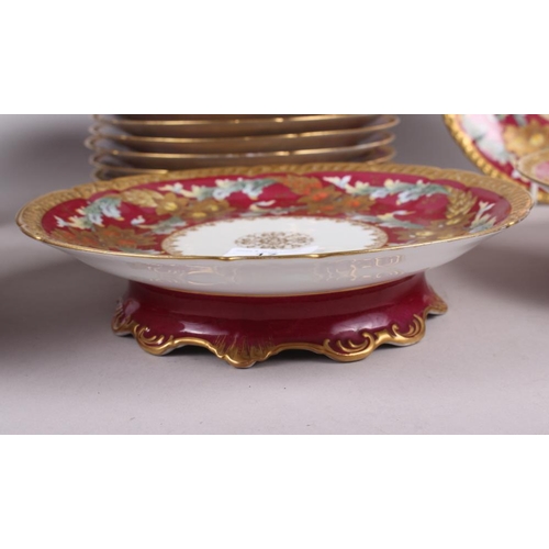 17 - A 19th century French porcelain dessert service with floral and gilt decoration on a crimson ground