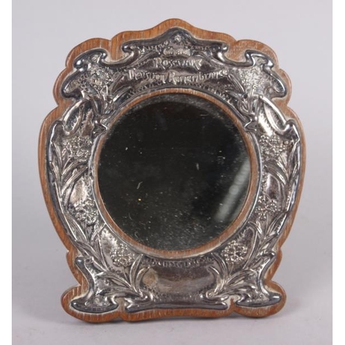 314 - An Edwardian silver faced oak strut mirror, embossed 