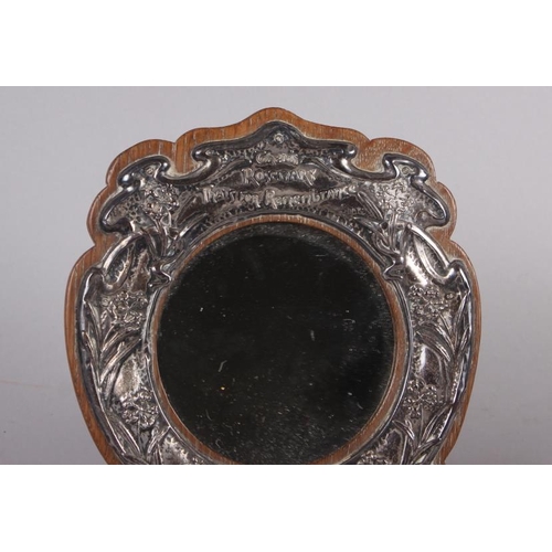 314 - An Edwardian silver faced oak strut mirror, embossed 